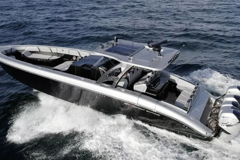 Slide: The Image of 2019 Midnight Express 43 Open boat cruising on the ocean with powerful engines. - 3