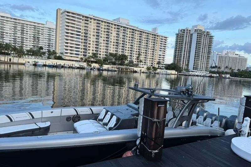 Slide: The Image of 2019 Midnight Express 43 Open boat docked by waterfront buildings. - 8