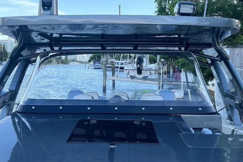 Slide: The Image of 2019 Midnight Express 43 Open boat docked, showcasing sleek design and spacious seating. - 9