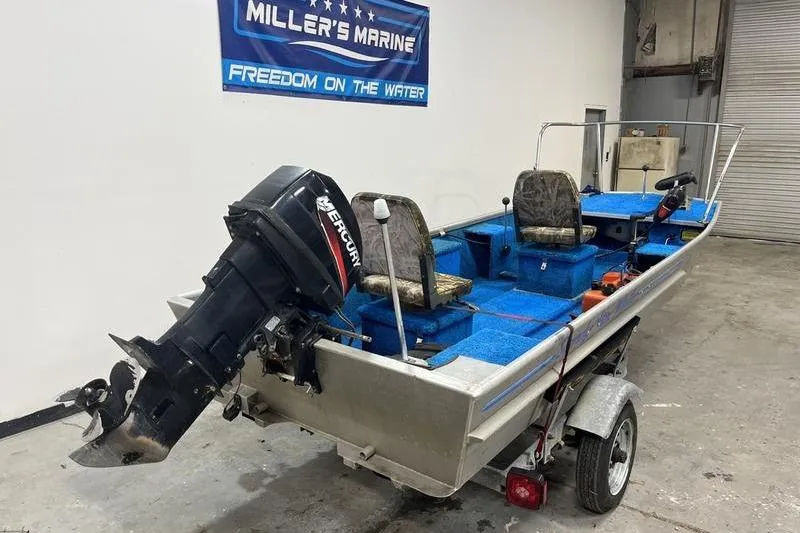 Slide: The Image of 2006 SCANDY WHITE 1310 boat with Mercury outboard motor on trailer in garage. - 3