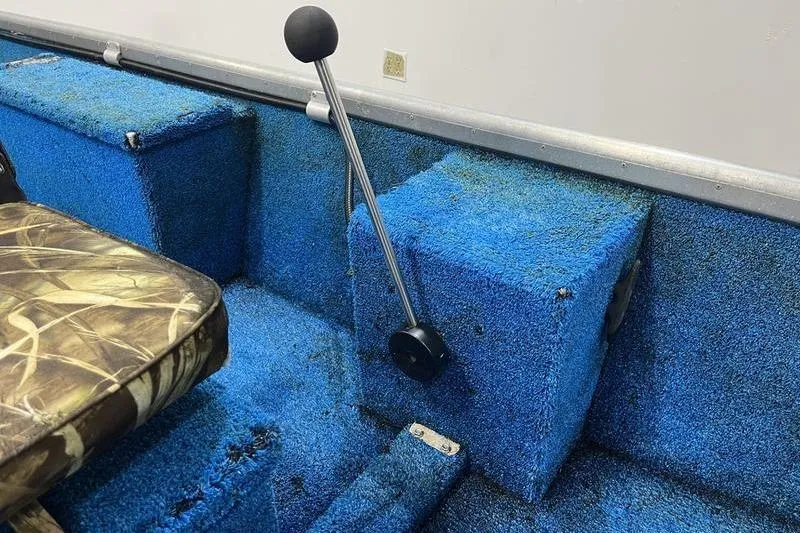 Slide: The Image of 2006 SCANDY WHITE 1310 boat interior with blue carpet and camo seat. - 7