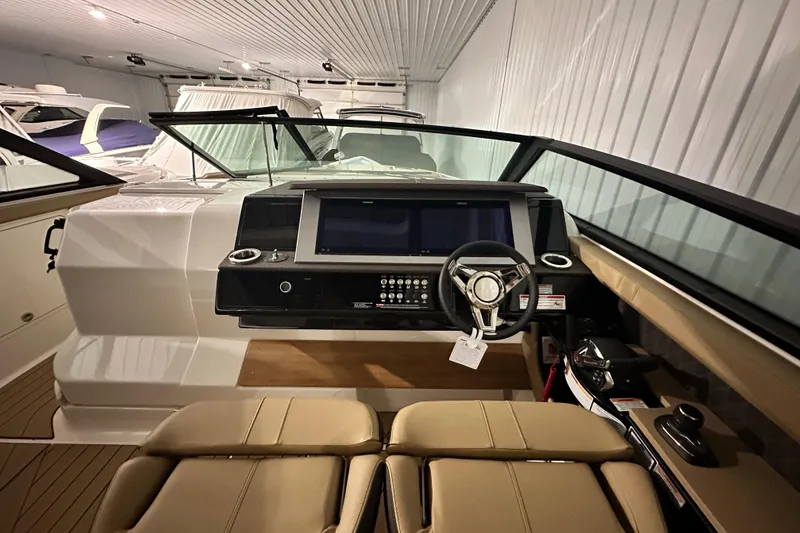 Slide: The Image of Interior view of 2026 Sea Ray SLX 400 boat cockpit with modern controls and steering wheel. - 13