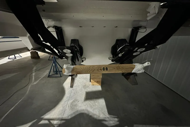 Slide: The Image of Underbody view of 2026 Sea Ray SLX 400 boat in a garage setting. - 17