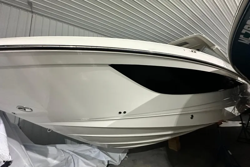 Slide: The Image of 2026 Sea Ray SLX 400 boat in storage, sleek white hull design. - 18