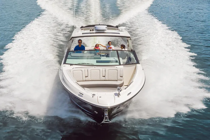 Slide: The Image of Manufacturer Provided Image: 2025 Sea Ray SLX 400 cruising on open water with passengers enjoying the ride. - 2
