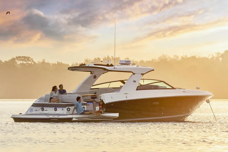Slide: The Image of Manufacturer Provided Image: 2025 Sea Ray SLX 400 yacht cruising at sunset with passengers enjoying the view. - 3