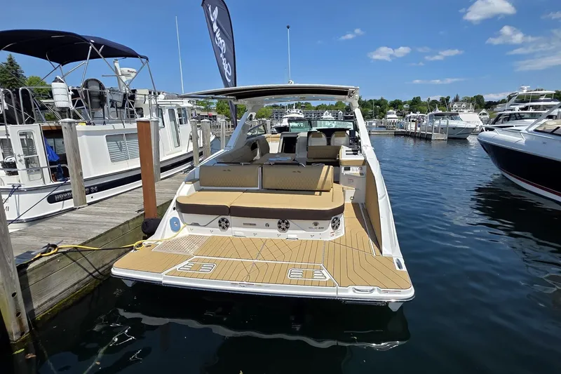 Slide: The Image of 2026 Sea Ray SLX 400 luxury boat docked at marina under clear blue sky. - 3