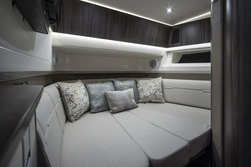 Slide: The Image of 2026 Sea Ray SLX 400 boat interior with beige seating and modern design. - 9