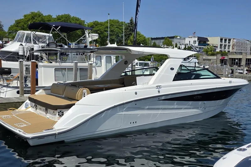 The Image of 2026 Sea Ray SLX 400 luxury boat docked at marina, showcasing sleek design and spacious deck. - 0