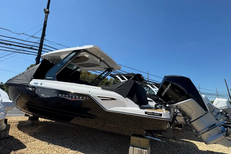 Slide: The Image of 2026 Monterey Elite 30 OB boat displayed outdoors on a sunny day. - 1