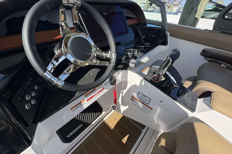 Slide: The Image of 2026 Monterey Elite 30 OB boat cockpit with modern steering and controls. - 12