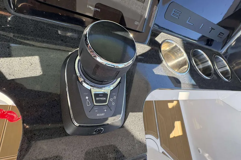 Slide: The Image of Control panel of 2026 Monterey Elite 30 OB boat with joystick and cup holders. - 14