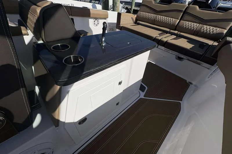 Slide: The Image of Luxurious interior of 2026 Monterey Elite 30 OB boat with seating and table. - 18