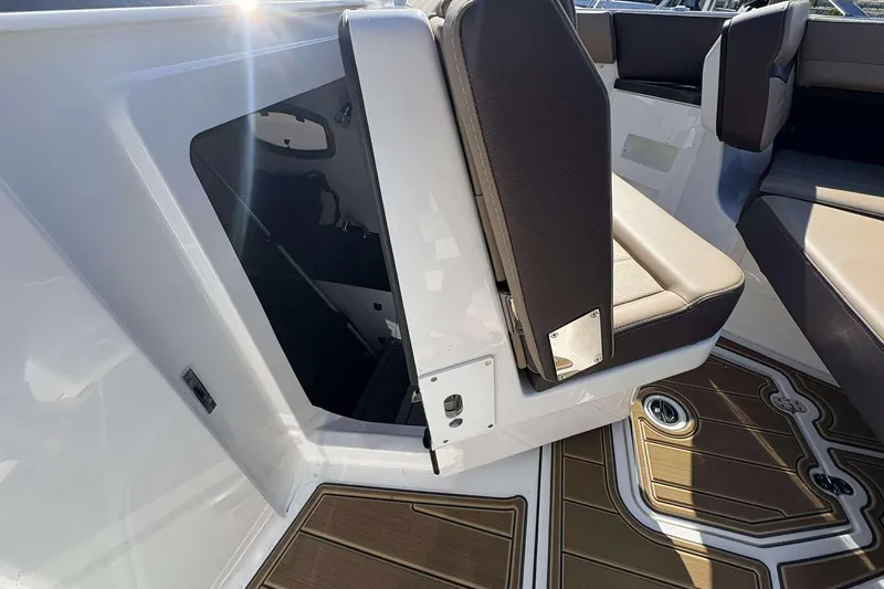 Slide: The Image of 2026 Monterey Elite 30 OB boat interior with seating and storage compartment. - 19