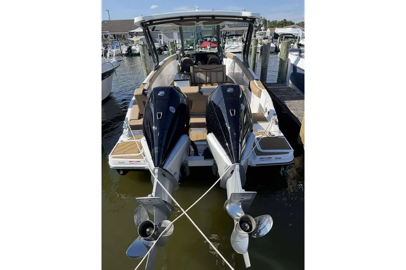 Slide: The Image of 2026 Monterey Elite 30 OB boat docked, featuring dual outboard engines. - 22