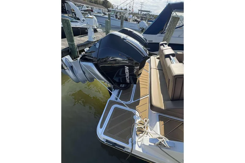 Slide: The Image of 2026 Monterey Elite 30 OB boat with dual Mercury outboard engines at a marina. - 23