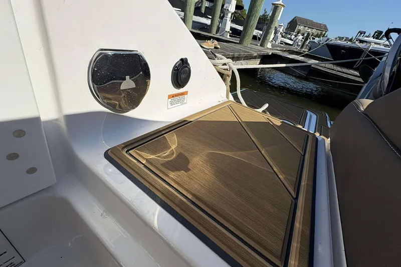 Slide: The Image of 2026 Monterey Elite 30 OB boat deck with wood finish, docked at marina. - 24