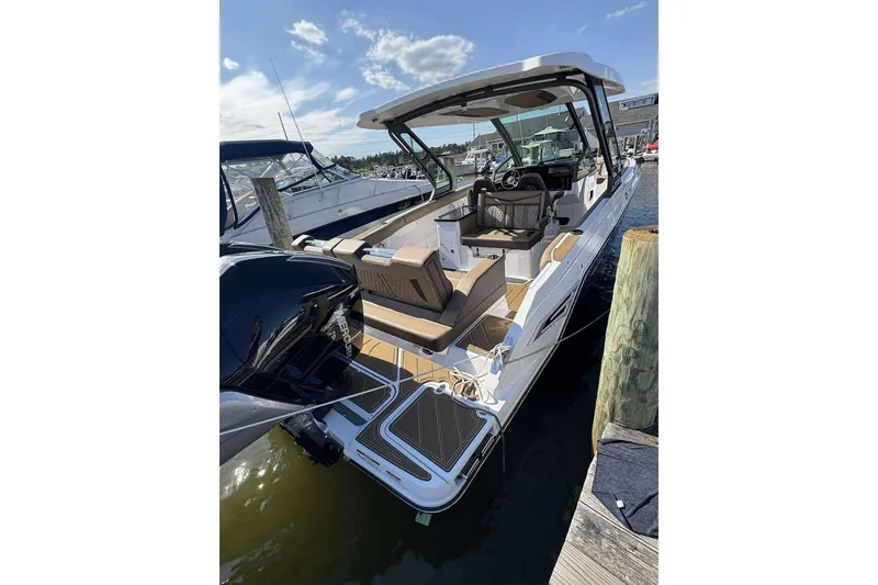 Slide: The Image of 2026 Monterey Elite 30 OB boat docked, showcasing sleek design and spacious seating. - 3