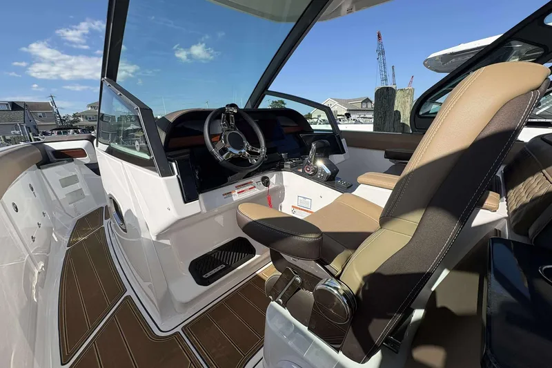 Slide: The Image of 2026 Monterey Elite 30 OB boat interior with modern steering and luxurious seating. - 5