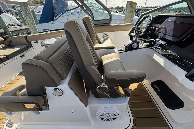 Slide: The Image of 2026 Monterey Elite 30 OB boat interior with luxurious seating and modern dashboard controls. - 6