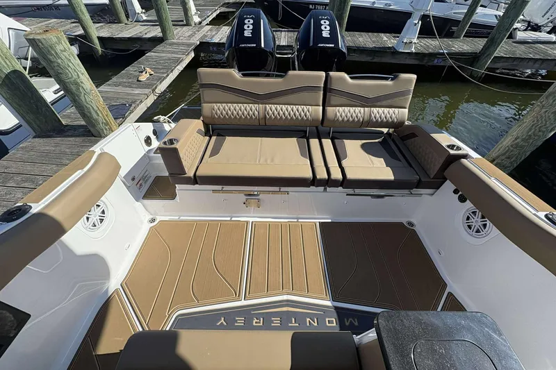 Slide: The Image of 2026 Monterey Elite 30 OB boat interior with luxurious seating and dual outboard engines at dock. - 7