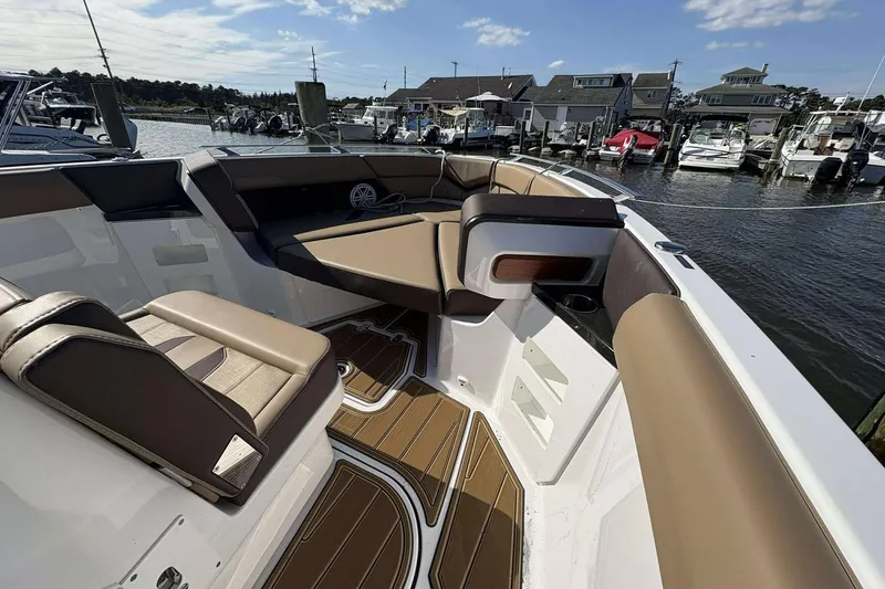 Slide: The Image of 2026 Monterey Elite 30 OB boat interior with luxurious seating and waterfront view. - 8