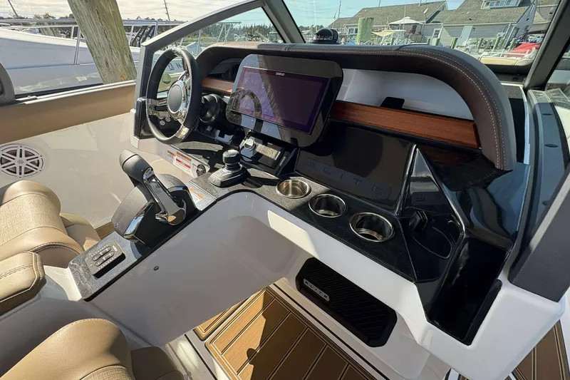 Slide: The Image of 2026 Monterey Elite 30 OB boat dashboard with modern controls and touchscreen display. - 9