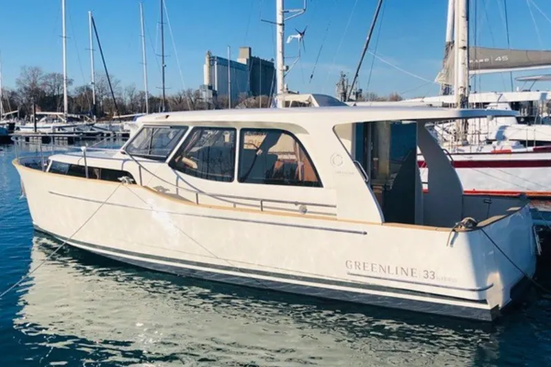 Slide: The Image of 2019 Greenline 33 Hybrid yacht docked in a marina, showcasing sleek design and eco-friendly features. - 1