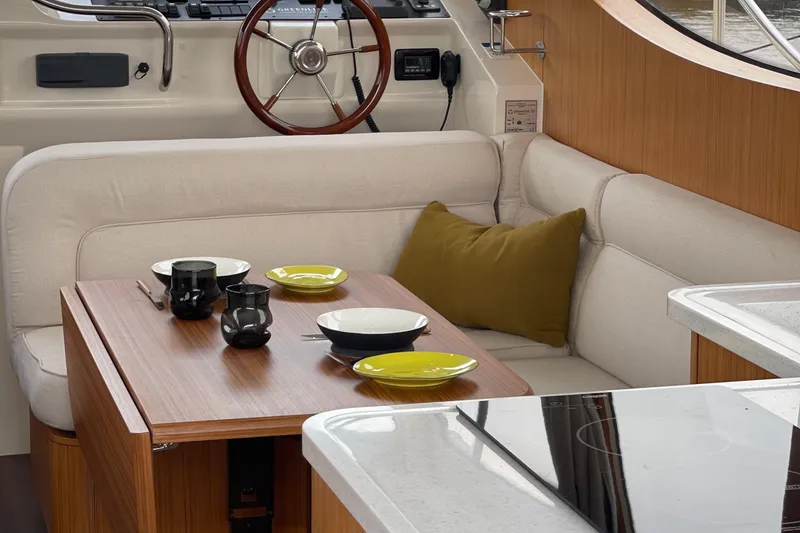 Slide: The Image of Interior of 2019 Greenline 33 Hybrid yacht with cozy dining area and modern decor. - 10