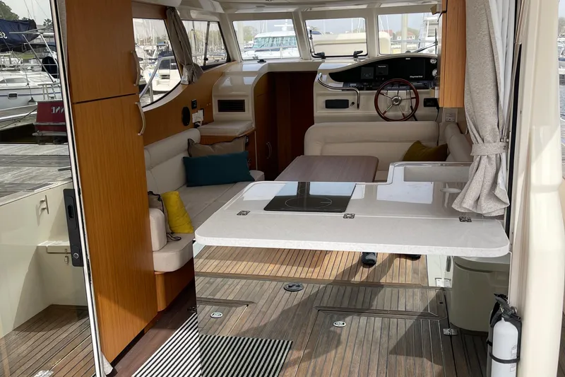 Slide: The Image of Interior of 2019 Greenline 33 Hybrid yacht with modern seating and wooden accents. - 11