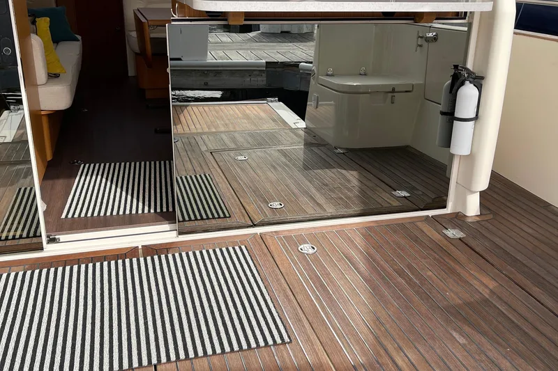 Slide: The Image of Interior view of 2019 Greenline 33 Hybrid yacht with wooden flooring and striped rugs. - 12