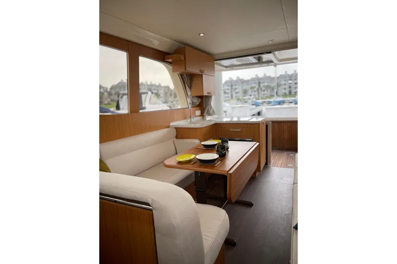 Slide: The Image of Interior of 2019 Greenline 33 Hybrid yacht with dining area and scenic window view. - 14