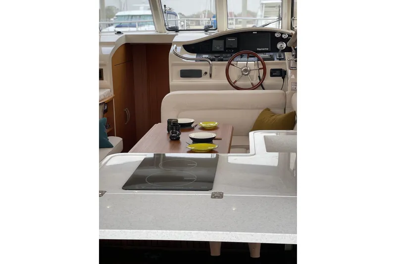 Slide: The Image of Interior of 2019 Greenline 33 Hybrid yacht with modern helm and dining area. - 15