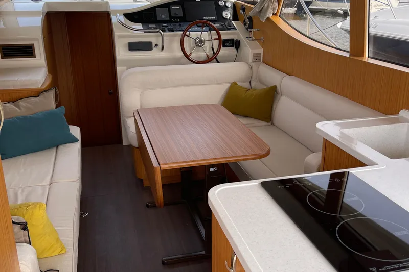 Slide: The Image of Interior of 2019 Greenline 33 Hybrid yacht with modern seating and kitchen area. - 20