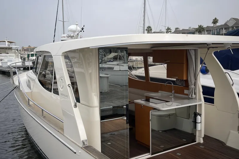 Slide: The Image of 2019 Greenline 33 Hybrid yacht with open kitchen, docked at marina. - 23
