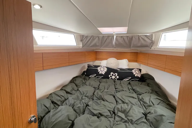 Slide: The Image of Cozy cabin interior of 2019 Greenline 33 Hybrid yacht with comfortable bedding. - 24