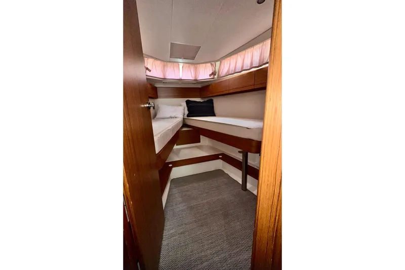 Slide: The Image of 2019 Greenline 33 Hybrid cabin interior with twin beds and wooden finish. - 27