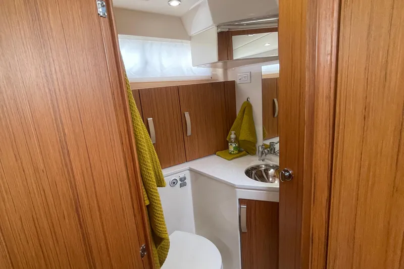 Slide: The Image of 2019 Greenline 33 Hybrid yacht bathroom with wood cabinetry and modern fixtures. - 28