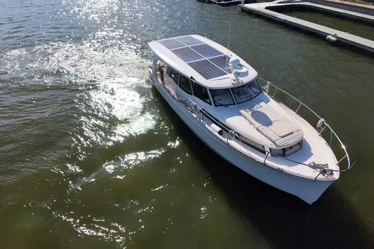 Slide: The Image of 2019 Greenline 33 Hybrid boat with solar panels on water. - 4