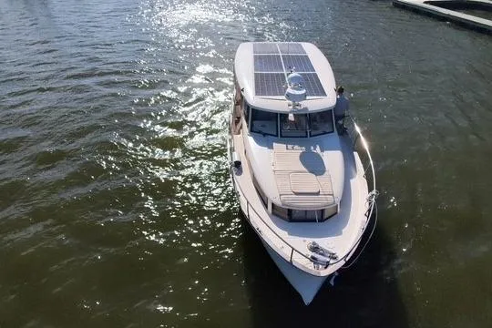 Slide: The Image of 2019 Greenline 33 Hybrid boat with solar panels on water. - 5