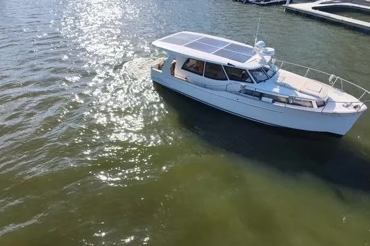 Slide: The Image of 2019 Greenline 33 Hybrid boat cruising on sunny waters. - 6