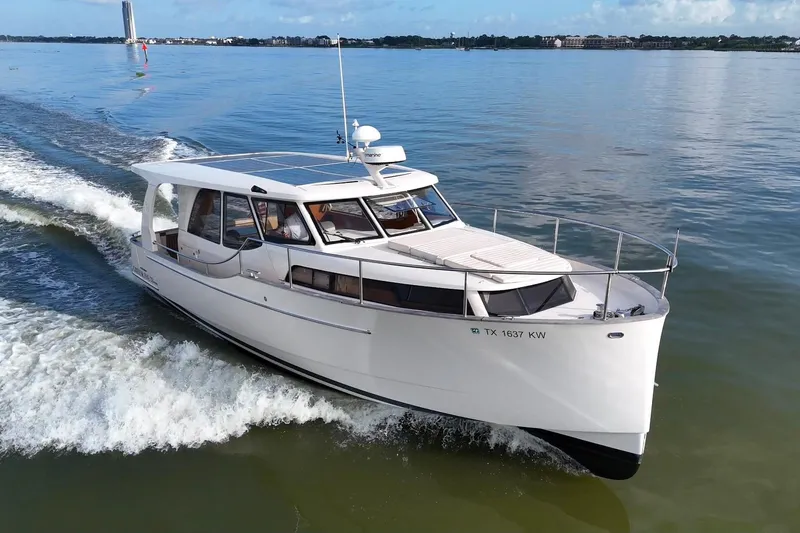 Slide: The Image of 2019 Greenline 33 Hybrid yacht cruising on calm waters, showcasing sleek design and solar panels. - 8