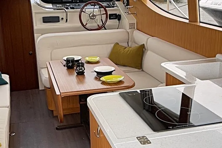 Slide: The Image of Interior of 2019 Greenline 33 Hybrid yacht with modern kitchen and cozy seating area. - 9