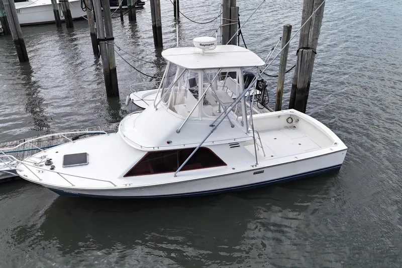 Slide: The Image of 1985 Blackfin 32 Flybridge boat docked in marina, aerial view. - 12