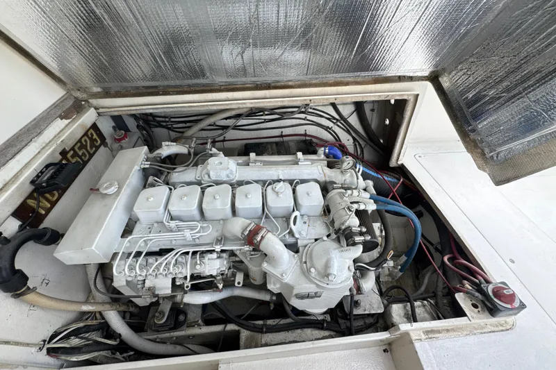 Slide: The Image of Engine compartment of a 1985 Blackfin 32 Flybridge boat, showcasing detailed mechanical components. - 23