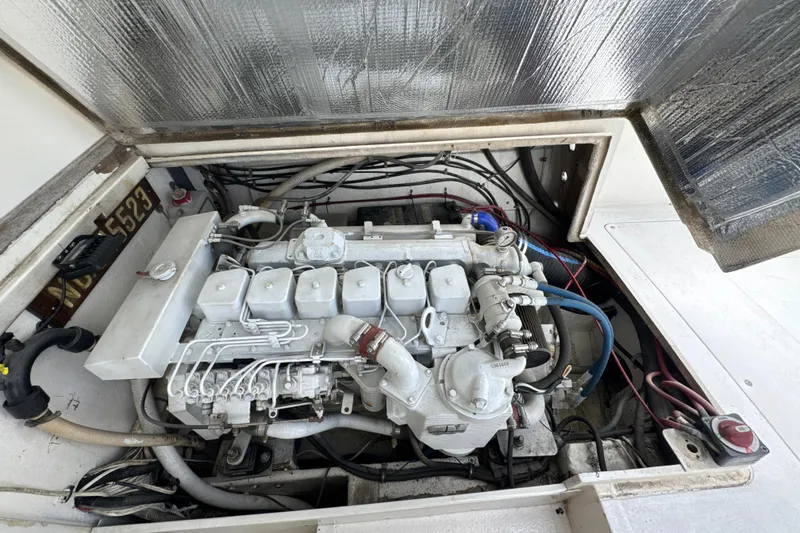 Slide: The Image of Engine compartment of a 1985 Blackfin 32 Flybridge boat, showcasing detailed mechanical components. - 24