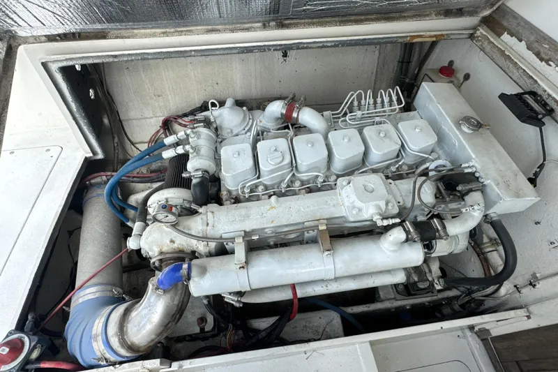 Slide: The Image of Engine compartment of a 1985 Blackfin 32 Flybridge boat, showcasing detailed mechanical components. - 25