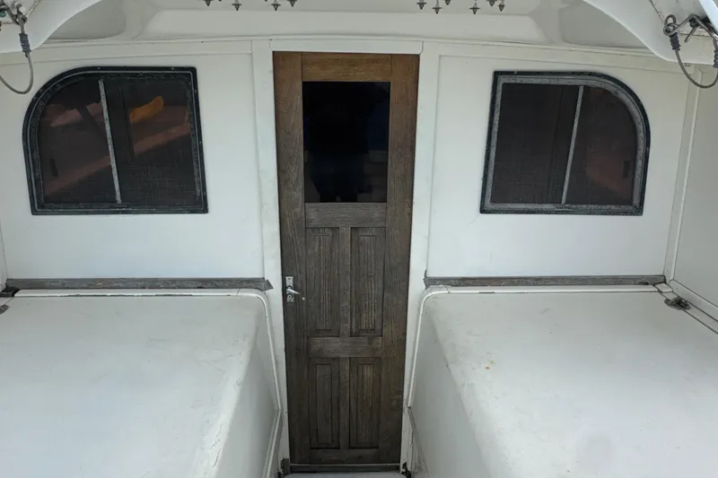 Slide: The Image of 1985 Blackfin 32 Flybridge interior with wooden door and two windows. - 28