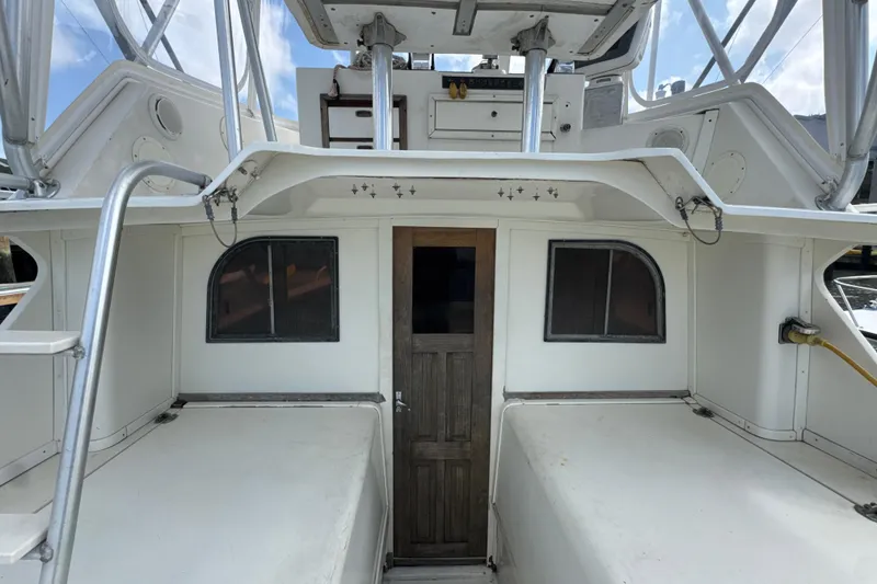 Slide: The Image of 1985 Blackfin 32 Flybridge boat interior with wooden door and windows. - 29