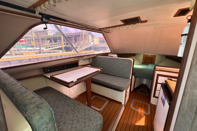 Slide: The Image of 1985 Blackfin 32 Flybridge interior with seating, table, and wood flooring. - 30
